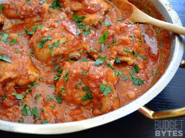 Pan of cooked Chicken Arrabbiata garnished with parsley