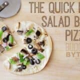 A salad bar pizza topped with fresh ingredients.
