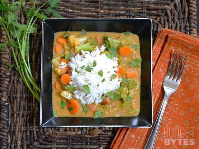 Top view of a bowl of Coconut Vegetable Curry with fork on the side