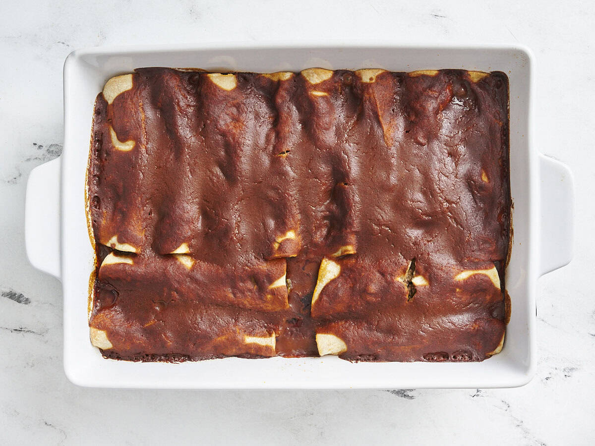 Baked beef enchiladas in a baking dish.