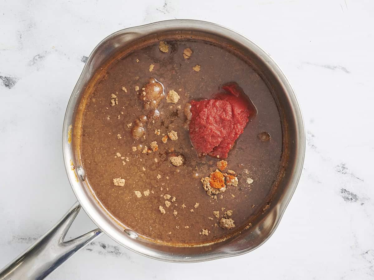 Enchilada sauce ingredients in a skillet.