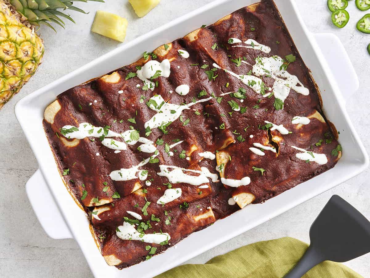 Overhead view of beef enchiladas in a baking dish.