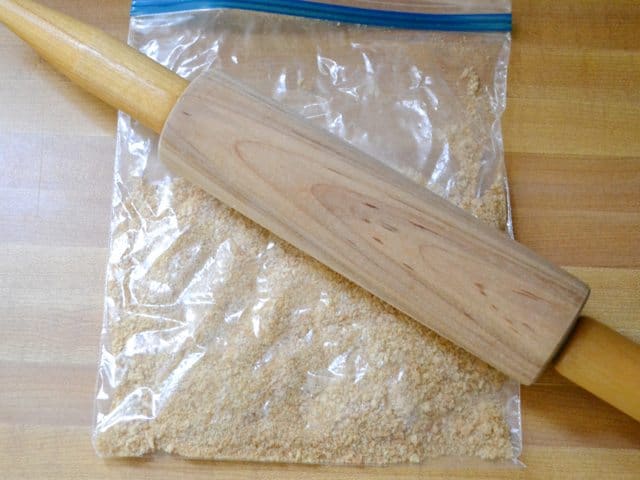 Graham crakers in zip lock bag with rolling pin to smash them