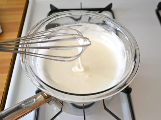 Whisking marshmallow mixture in double boiler on stove top