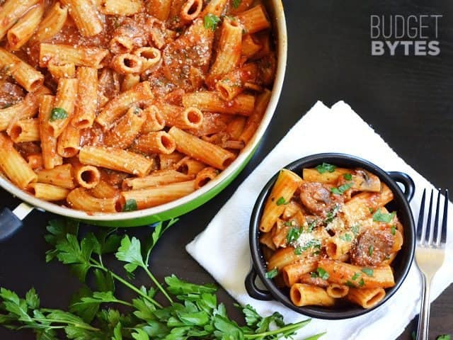 Pot of One Pot Sausage & Mushroom Pasta with a small bowl served