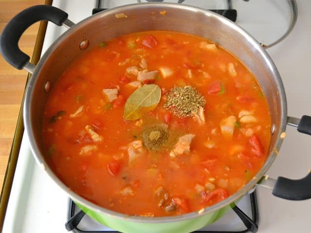 Tomatoes and chicken broth added to pot with other ingredients