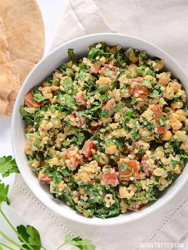 top view of a bowl of Falafel Salad with pita bread on the side
