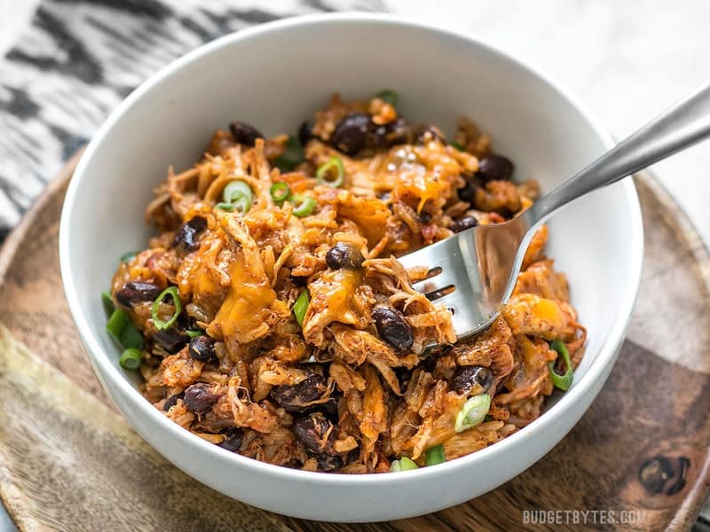 If you're looking for a quick and easy dinner, this Southwest Chicken Skillet is it! Precooked chicken makes this dinner possible in about 30 minutes. BudgetBytes.com Bowl of southwest chicken skillet with fork in it