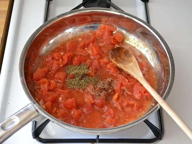 Tomatoes and seasoning added to skillet