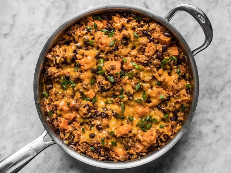 Melted Cheese and Green Onions on top of cooked skillet