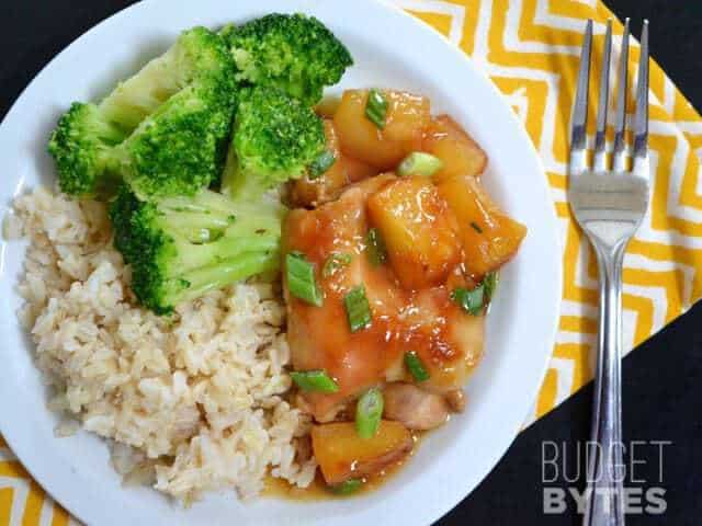 Pineapple Teriyaki Chicken Thigh plated with a side of broccoli and rice, fork on the side