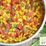 A close-up of sautéed corn and tomatoes in a bowl.
