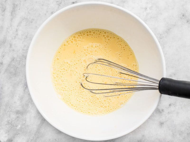 Milk and Eggs whisked with whisk in mixing bowl