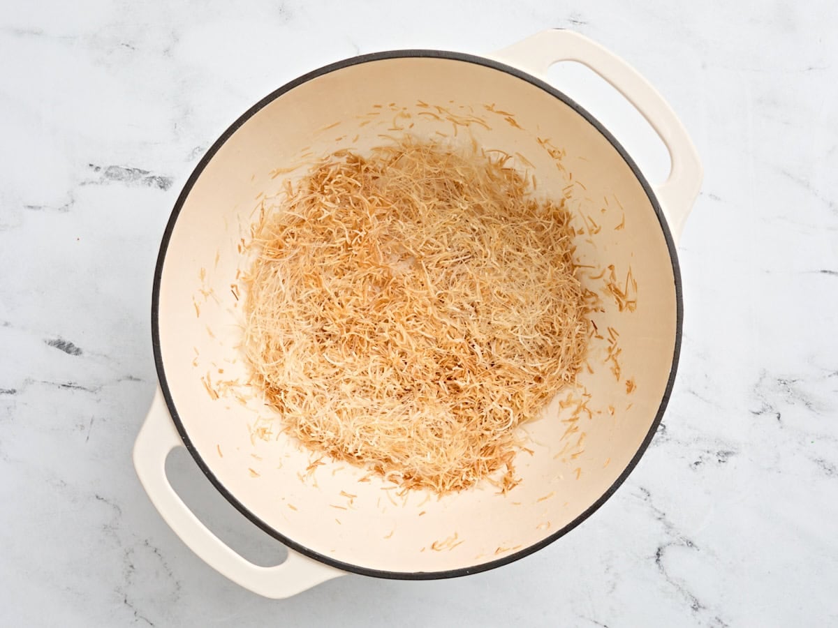 Vermicelli noodles toasting in a casserole pot.