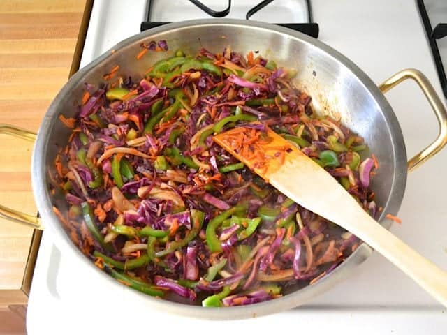 Stir Fry Sauce added to cooked vegetables in skillet