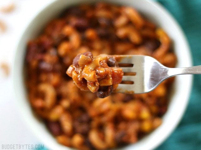 This super hearty One Pot Chili Pasta is bursting with southwest chili flavor, protein, and fiber. It's a meal in a bowl that the whole family will love. Budgetbytes.com Close up of a forkful of One Pot Chili Pasta
