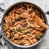 This super easy and satisfying, "sweep the kitchen" Penne Pasta with Sausage and Greens is an entire meal in one pot. Cook once, eat all week.