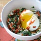 A close-up of spinach rice breakfast bowl with eggs.