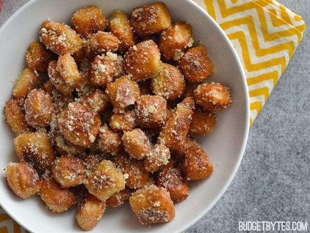Bowl of Parmesan Garlic Pretzel Bites with a yellow chevron napkin underneath