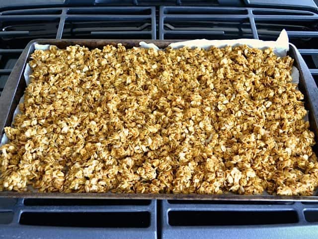 Pumpkin Granola spread on baking sheet ready to bake