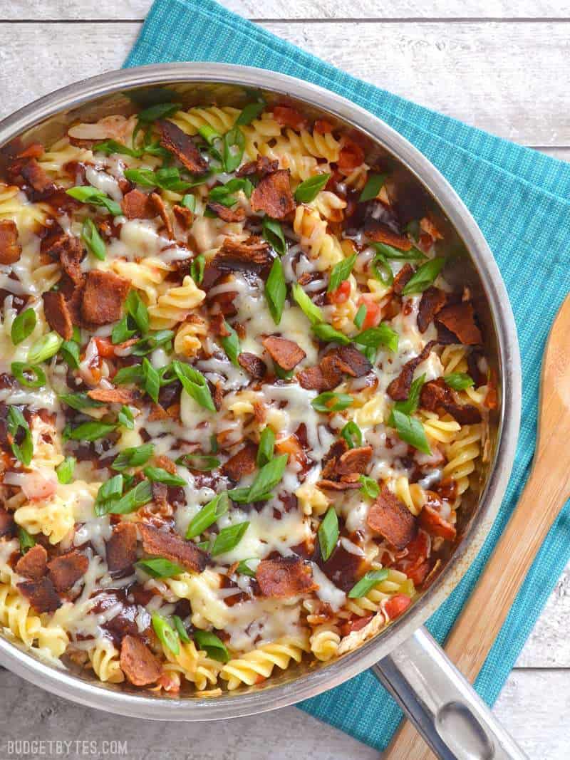 Finished skillet sitting on blue stopped napkin with a wooden spoon on the side