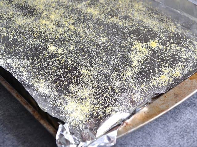 Baking sheet lined with tin foil, sprayed with non stick spray and sprinkled with cornmeal