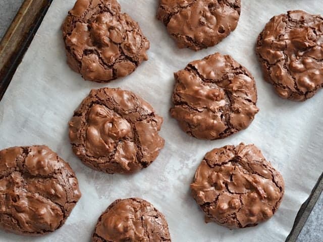 Baked Chocolate Crinkles on baking sheet lined with parchment paper