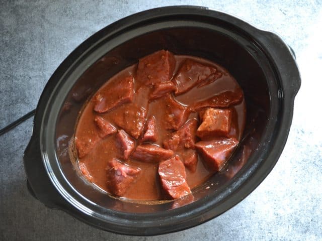 Beef chunks and sauce in slow cooker