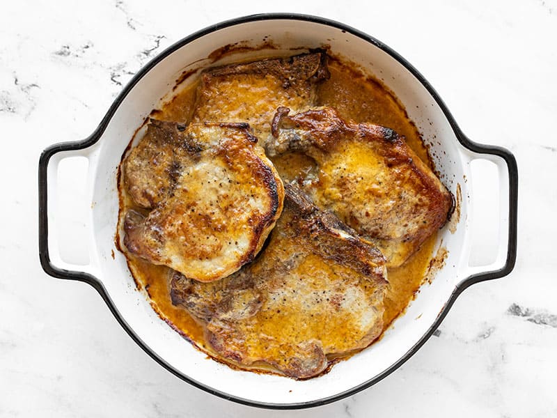 baked honey mustard pork chops in a casserole dish