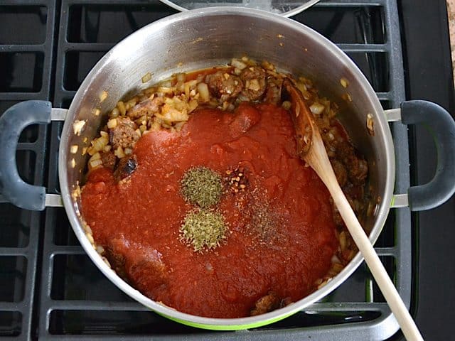 Tomatoes and Herbs added to skillet with other ingredients