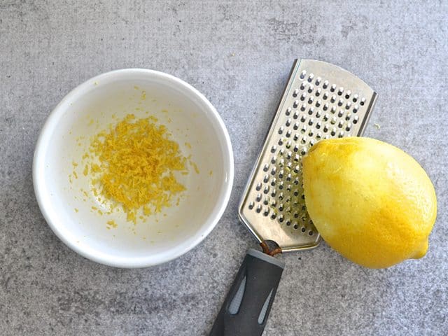 Zesting a lemon into a small bowl
