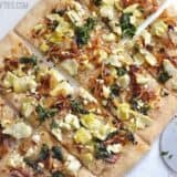 A flatbread topped with caramelized onions and artichokes.