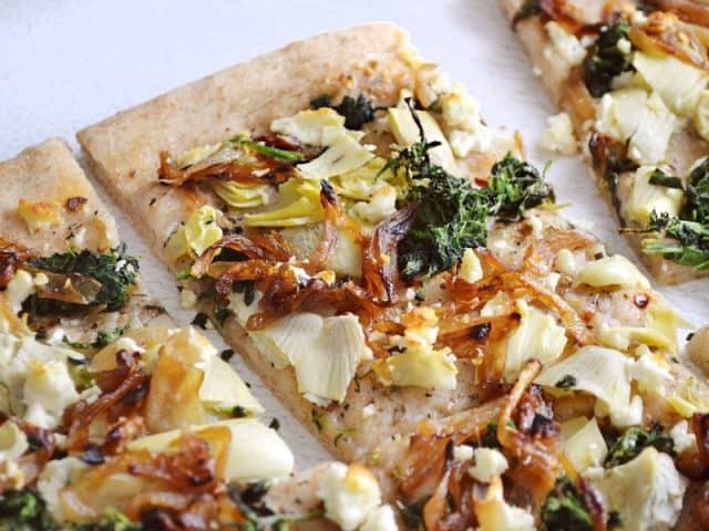 Top view of slices of Caramelized Onion and Artichoke FlatBread