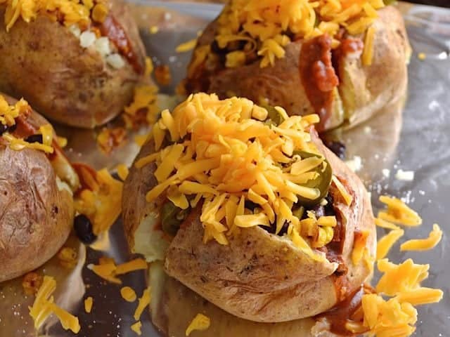 Shredded Cheddar Cheese sprinkled on top of each potato