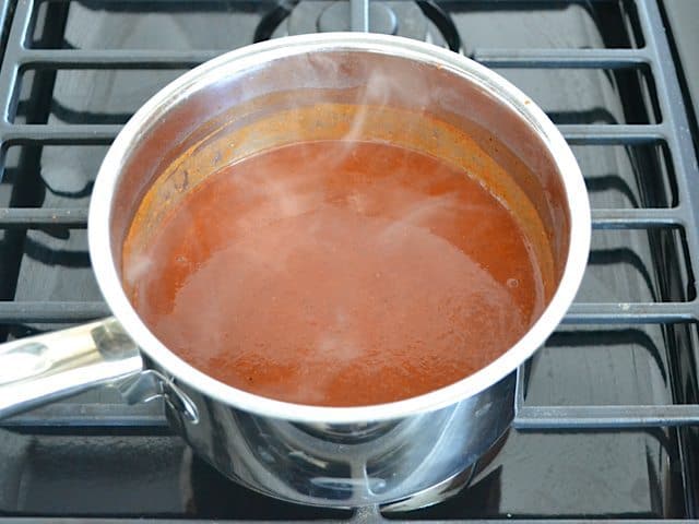 Red Enchilada Sauce in pot cooking on stove top