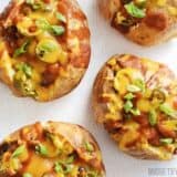 A close-up of nacho taters topped with cheese and jalapeños.