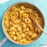 Pasta with creamy pumpkin sauce served in a skillet.