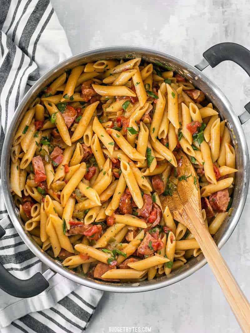 Celebrate like you're in Louisiana with this easy, filling, and inexpensive one pot favorite, Pastalaya. It's the shortcut pasta version of Jambalaya! BudgetBytes.com The full pot of finished Pastalaya with a wooden spoon