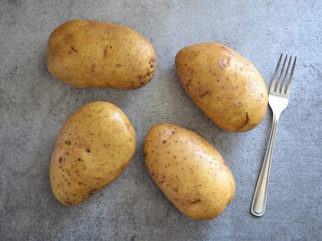 Four Russet Potatoes with fork
