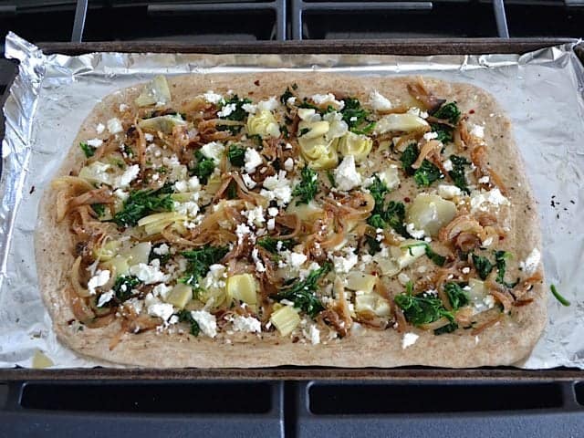 Toppings added to flatbread