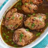 A close-up of balsamic chicken thighs on a serving dish.