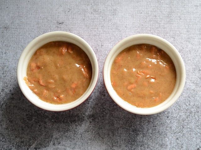 Two small ramekins filled with cake mixture