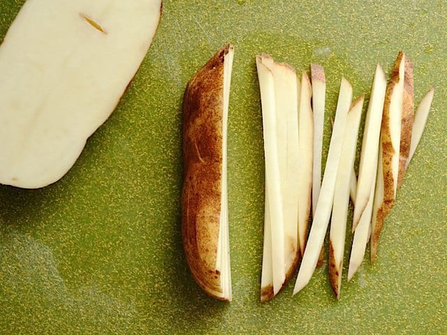 Cutting potato slices into small match stick pieces