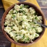 Creamy spinach and feta mashed potatoes in a bowl.