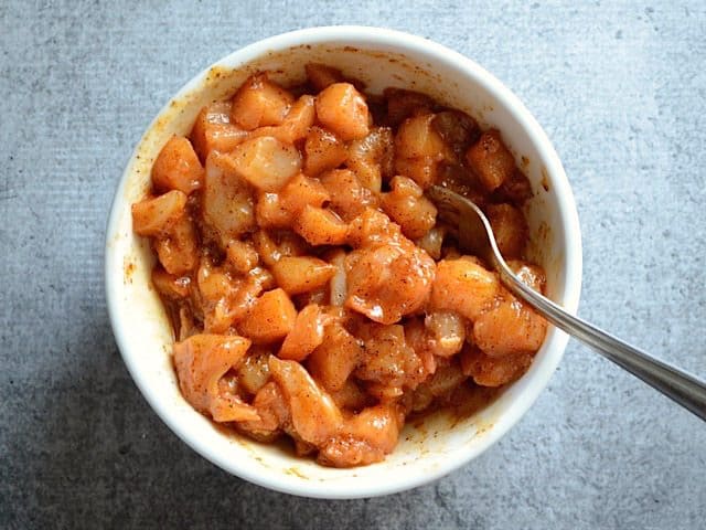 Chopped chicken added to spice mixture and coated