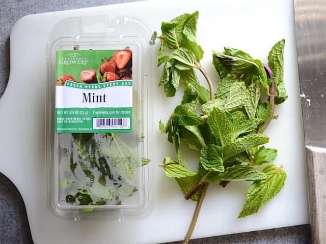 Package of Mint with some taken out to chop on cutting board