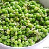 A close-up of minty pea salad in a bowl.