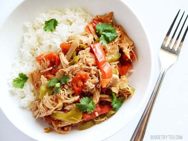 Top view of a bowl of Chicken Ropa Vieja with a fork on the side