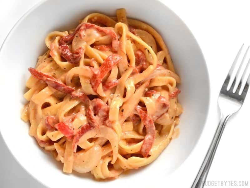 This smoky, sweet, and creamy One Pot Roasted Red Pepper Pasta cooks in one single pot and can be on the table in about 30 minutes. BudgetBytes.com Overhead shot of a bowl of One Pot Roasted Red Pepper Pasta