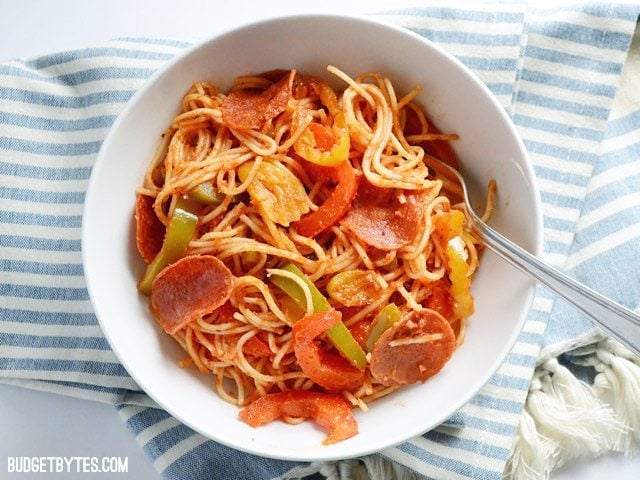Top view of a bowl of Three Pepper Pasta sitting on a stripped napkin